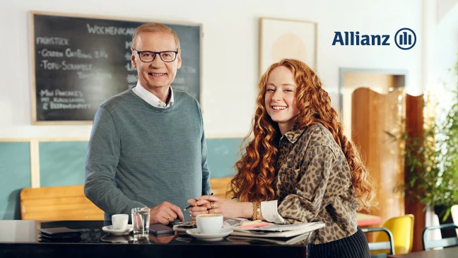 Günther Jauch mit rotharriger Frau am Schreibtisch
