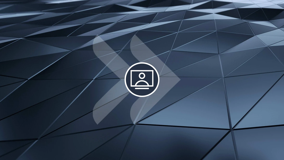 Ein geometrisches Muster aus dunklen, dreidimensionalen Flächen mit einem zentralen kreisförmigen Symbol, das ein rechteckiges Bildpiktogramm zeigt.